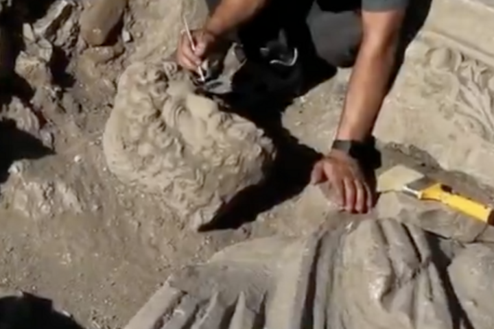 An archaeologist carefully cleans the newly unearthed statue at the excavation site in Aspendos Ancient City, Antalya. Credit: Türkiye's Minister of Culture and Tourism, Mehmet Nuri Ersoy, via X
