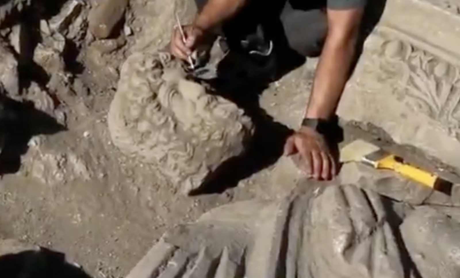 An archaeologist carefully cleans the newly unearthed statue at the excavation site in Aspendos Ancient City, Antalya. Credit: Türkiye's Minister of Culture and Tourism, Mehmet Nuri Ersoy, via X