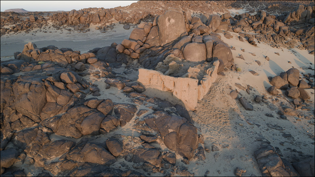 The church of Miseeda, with the ancient petroglyph visible on the rock behind it. 