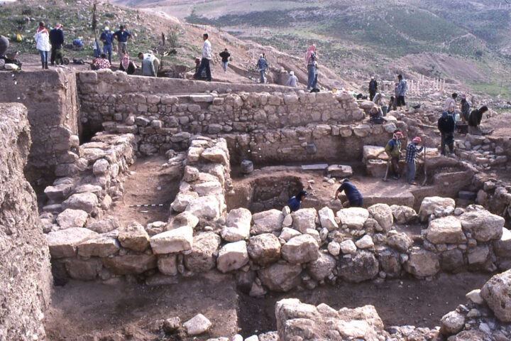 Archaeologists excavating stone walls and ancient structures at the Iron Age temple complex in Pella, Jordan.