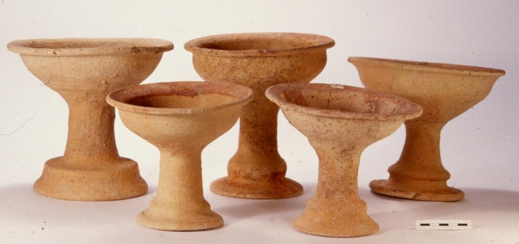 Five ancient ceramic ritual chalices recovered from a 3,000-year-old tomb at Pella, Jordan, some decorated with red painted markings.