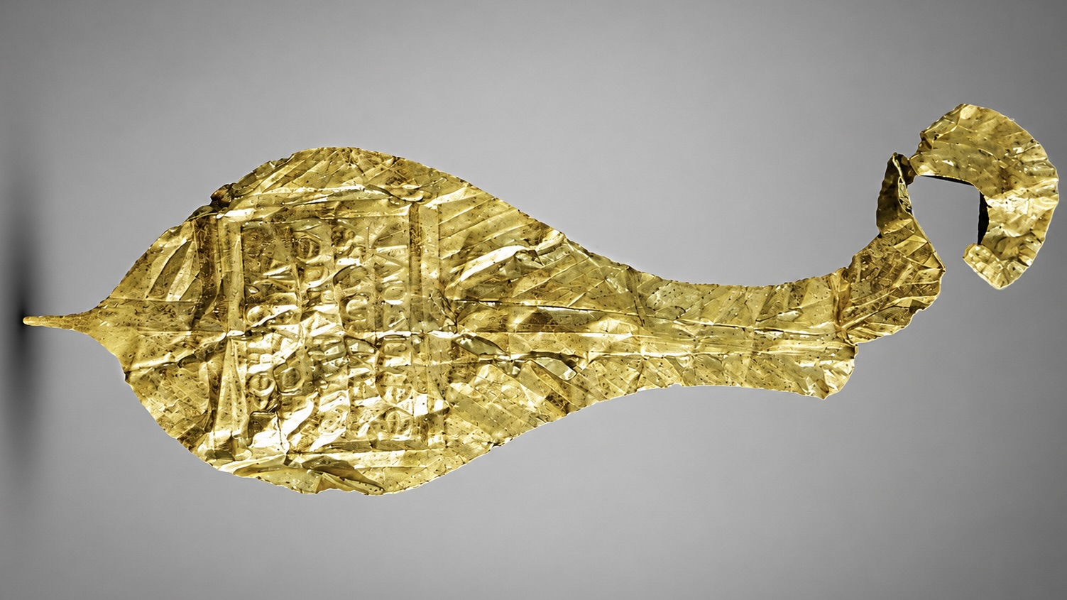 Ancient gold votive plaque bearing a Greek inscription dedicated to Jupiter Dolichenus, discovered at the Roman fortress of Apsaros in Georgia.