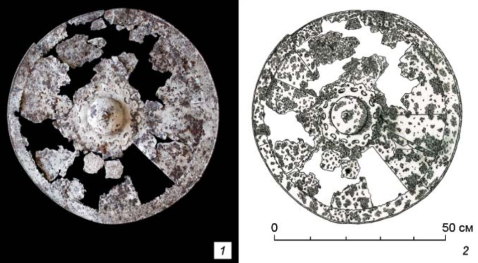 The rare Mongol-era iron shield from the Khakass-Minusinsk region, shown alongside a reconstruction of its original form.