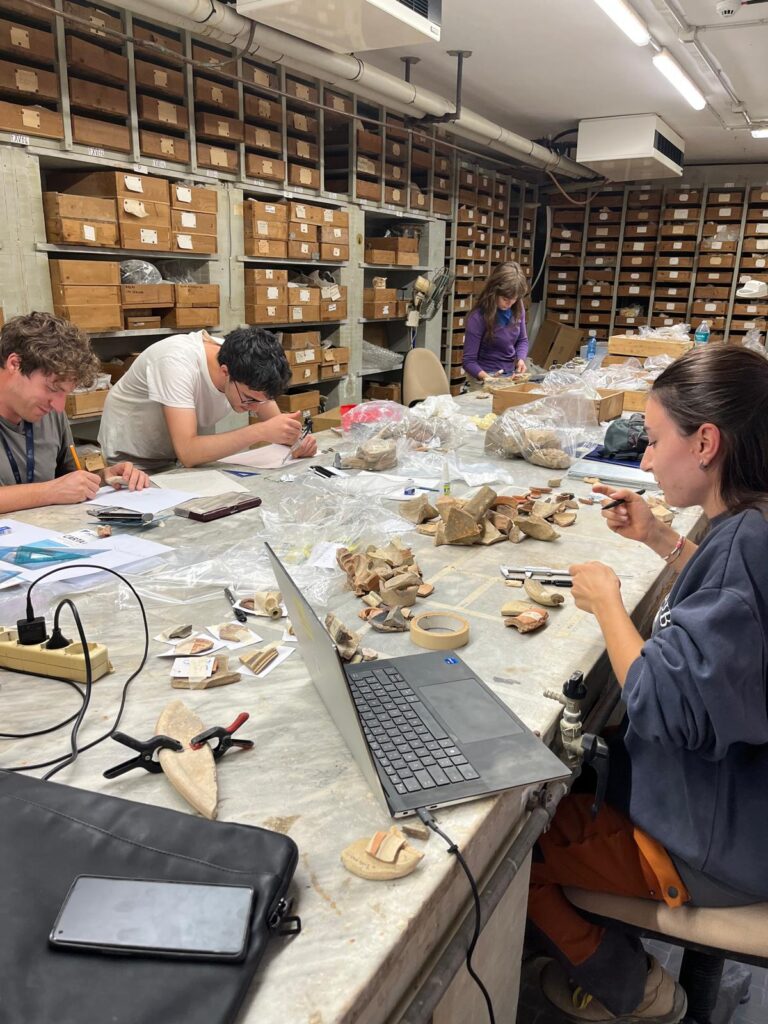 Archaeologists analyzing artifacts recovered during the 2026 excavations at Agrigento, Sicily.