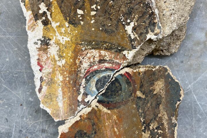 Ancient Roman wall painting fragment showing part of a man's face, uncovered at Agrigento in 2026.