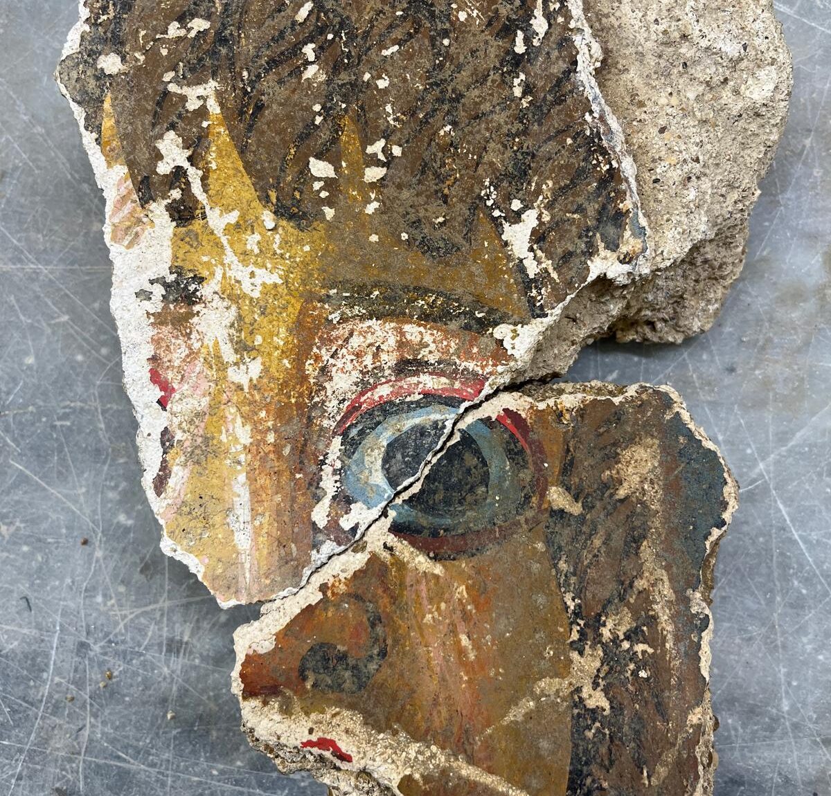 Ancient Roman wall painting fragment showing part of a man's face, uncovered at Agrigento in 2026.