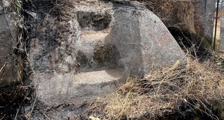 Archaeologists examining a rock-cut stairway exposed after a wildfire on Cerro Casitagua near Quito, Ecuador.