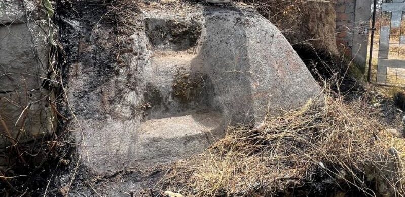 Archaeologists examining a rock-cut stairway exposed after a wildfire on Cerro Casitagua near Quito, Ecuador.